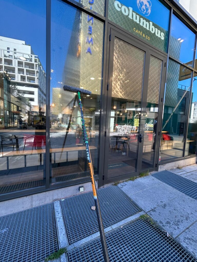 Matériel de nettoyage professionnel devant la vitrine d'un local commercial